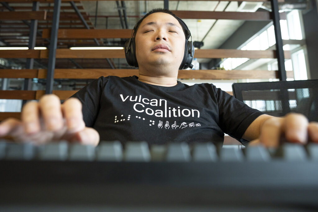 man with eyes closed wearing headphones