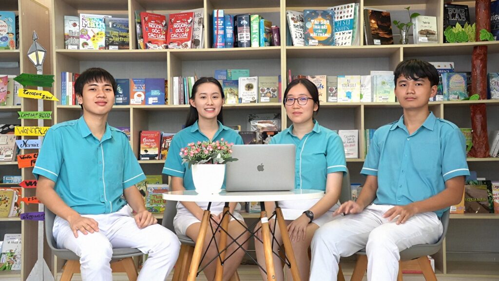 4 members, two boys and two girls, of the winner sitting in the school library