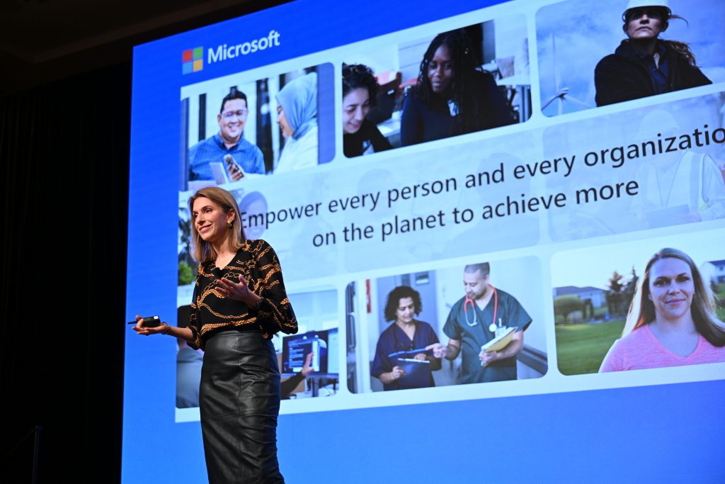 A woman giving a presentation on stage