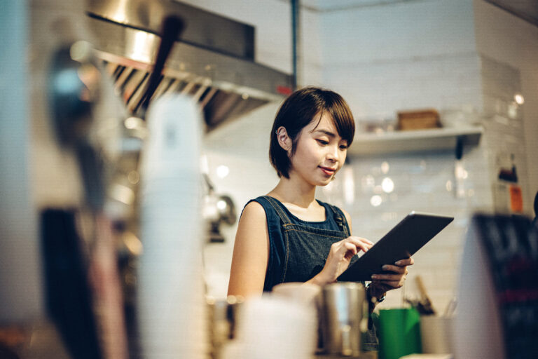 a woman using a tablet in a cafe